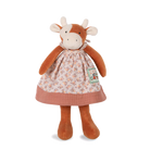 Stuffed cow toy with a floral dress on a white background