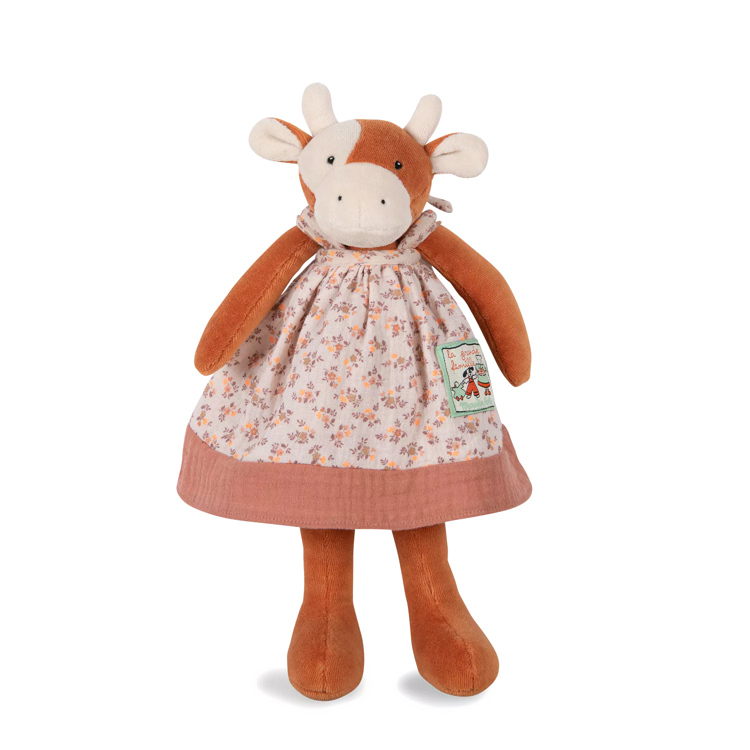 Stuffed cow toy with a floral dress on a white background