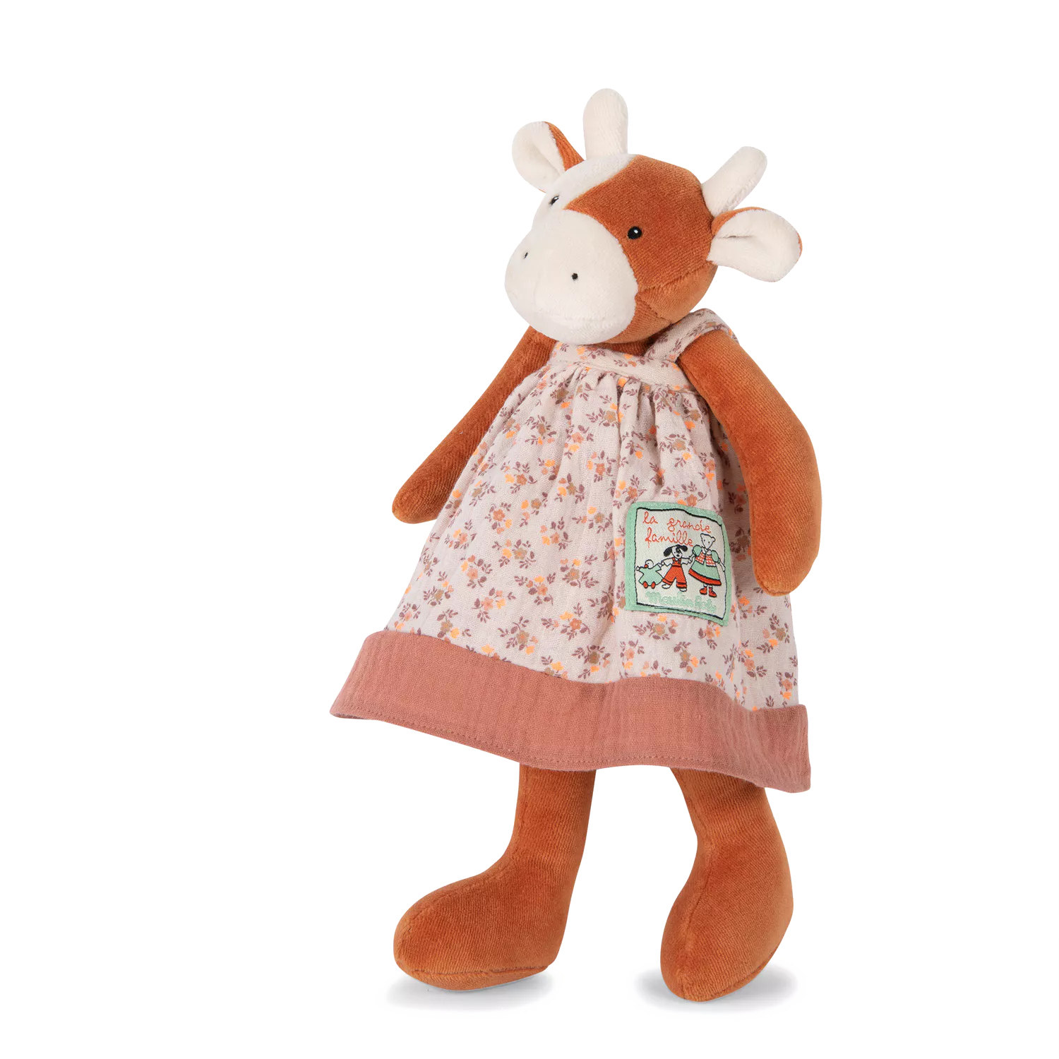 Plush toy cow wearing a floral dress on a white background