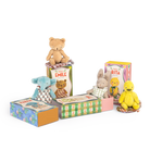 Collection of small stuffed animals from Moulin Roty Minouchkas in colorful boxes on a white background