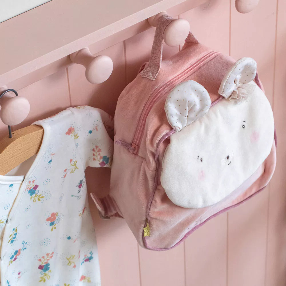 Baby pink children's backpack with a mous face hanging on a pink hanger against a pink background