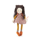 A handmade fabric doll with long dark brown braided hair, wearing a dusty pink patterned dress, mustard yellow top and socks, and orange shoes, standing against a plain white background.