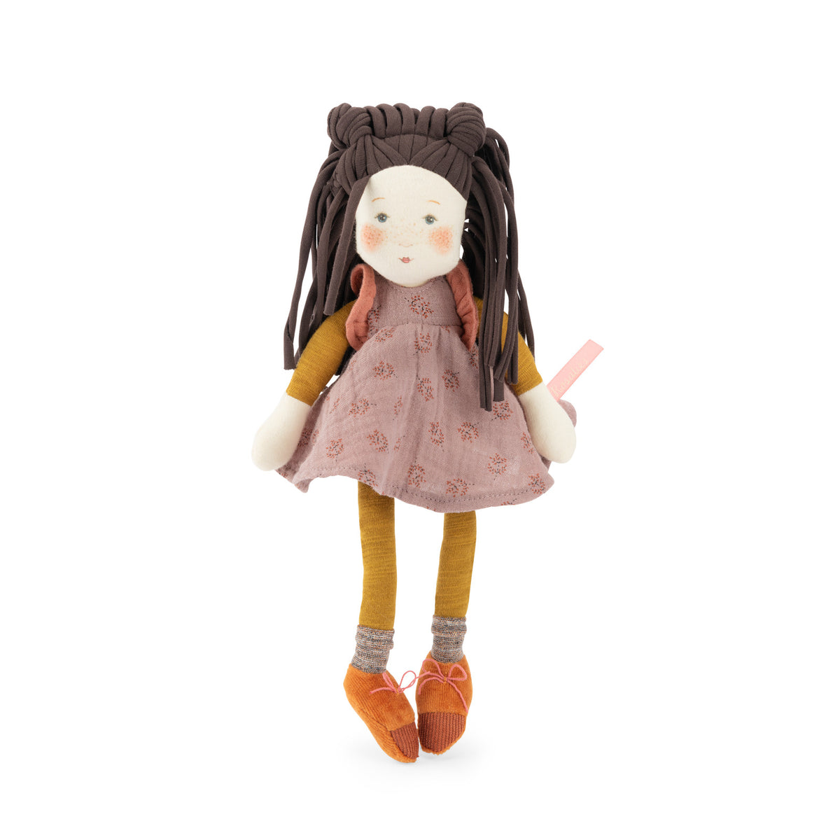 A handmade fabric doll with long dark brown braided hair, wearing a dusty pink patterned dress, mustard yellow top and socks, and orange shoes, standing against a plain white background.