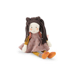 A handmade fabric doll with long dark brown braided hair, wearing a dusty pink patterned dress, yellow sleeves, and orange shoes, sitting against a plain white background.