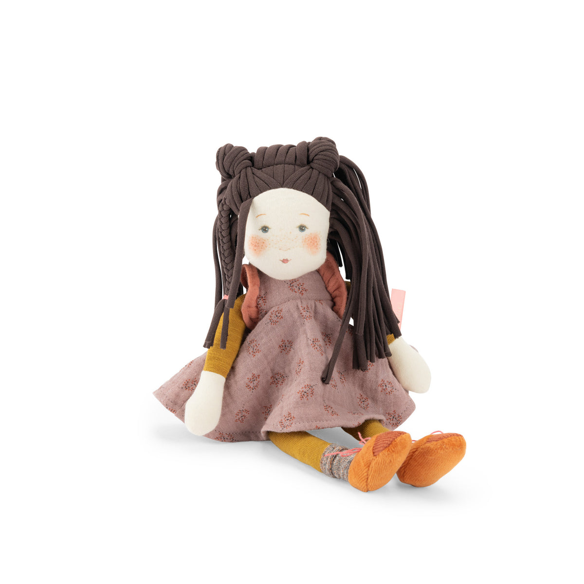 A handmade fabric doll with long dark brown braided hair, wearing a dusty pink patterned dress, yellow sleeves, and orange shoes, sitting against a plain white background.