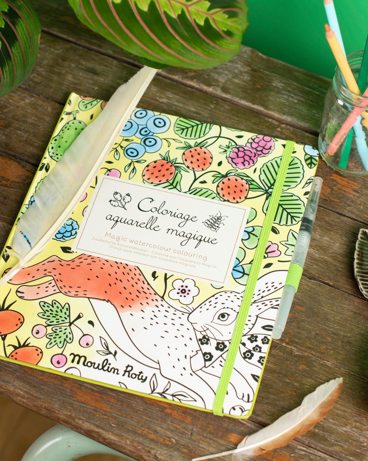 Coloring book with fox design on a wooden surface