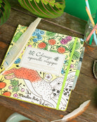 Coloring book with fox design on a wooden surface