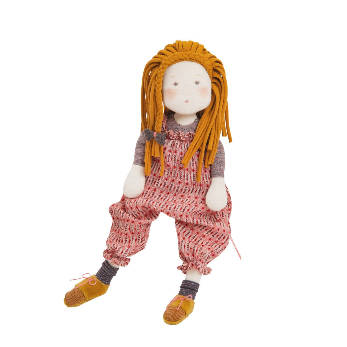 A handmade fabric doll with orange yarn hair, a white face, and a red-and-white patterned romper over a gray shirt, with yellow shoes, shown against a plain white background.