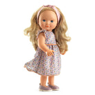 Doll with blonde hair and a floral dress on a white background
