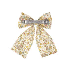 Floral patterned bow hair clip on a white background