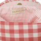 Close-up of a red and white checkered fabric with a 'Rockahula' label.