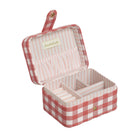 Open jewelry box with red and white checkered pattern on a white background
