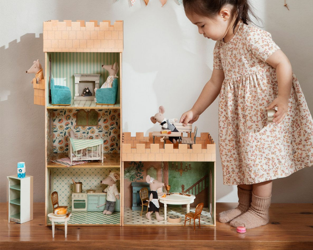 girl playing with the Maileg castle house and hall 