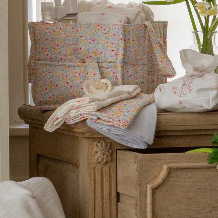 Floral-patterned fabric items on a wooden cabinet