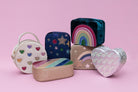 Collection of colorful kids handbags on a pink background