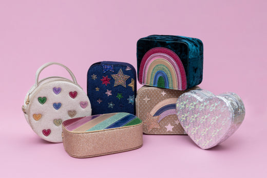 Collection of colorful kids handbags on a pink background