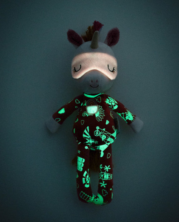 Glowing plush toy with a dark background