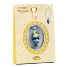 Blue figurine in a decorative yellow box with 'tinyly' branding