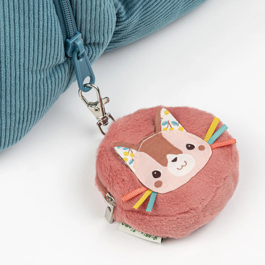 Pink childrens purse with a cat design and a blue strap on a white background