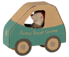 A small toy car shaped like a box, painted teal green on the lower half and natural kraft brown on the upper half, with the words 'Santa's Parcel Service' printed on the side. A stuffed hedgehog wearing a red Santa hat sits inside as the driver.