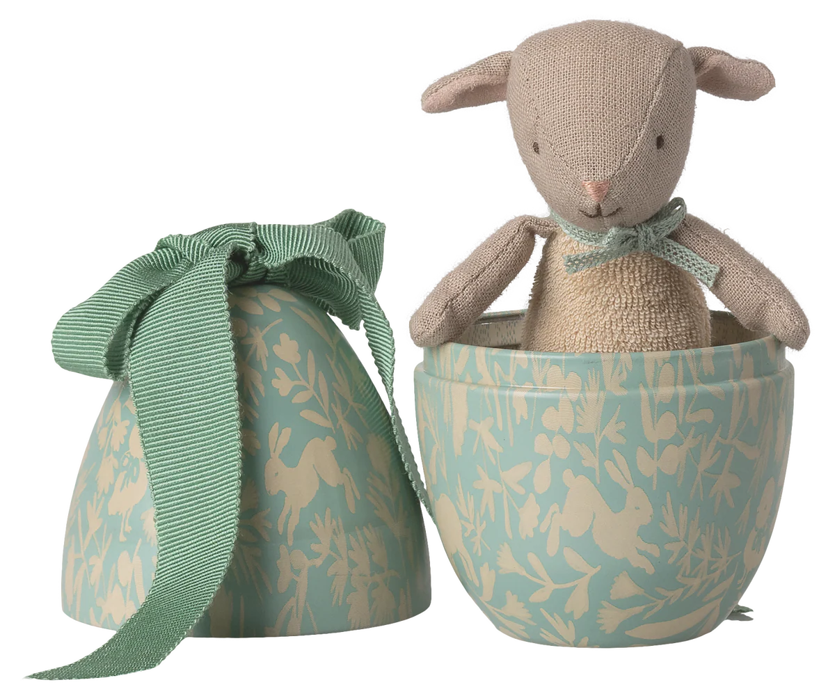 Stuffed animal toy in a decorative box with a matching bag on a white background