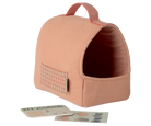 Pink pet carrier with a pet journal and cards on a white background