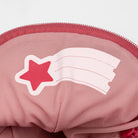 Close-up of a pink childs backpack with a star design on a white background