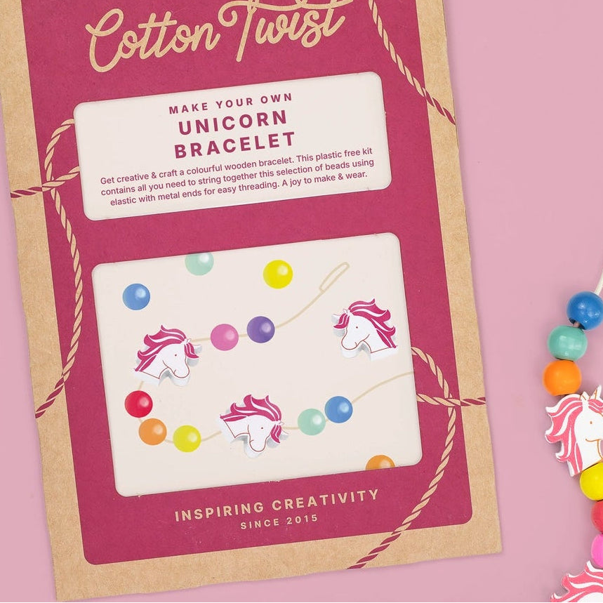 Cotton Twist unicorn bracelet kit with colorful beads on a pink background