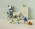 Maileg mice fixing a cycle in a dolls house